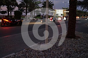 Bikers ride at night on the highway on Al-Marjan Island. United Arab Emirates