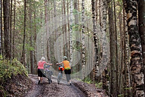 Bikers travel in difficult conditions in forest