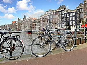 Bikes on the bridge along the canal in Amsterdam the Netherlands