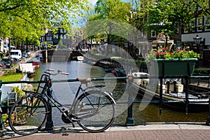 Bikes on the bridge that crosses the canal in Amsterdam