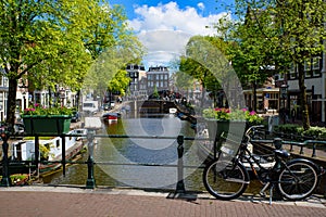 Bikes on the bridge that crosses the canal in Amsterdam