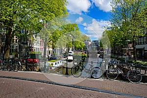 Bikes on the bridge that crosses the canal in Amsterdam