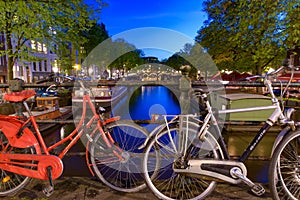 Bikes on the bridge that crosses the canal in Amsterdam