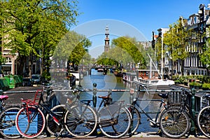 Bikes on the bridge that crosses the canal in Amsterdam