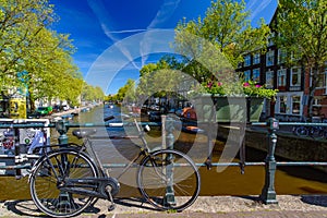 Bikes on the bridge that crosses the canal in Amsterdam