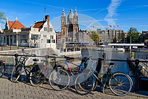 Bikes on the bridge that crosses the canal in Amsterdam