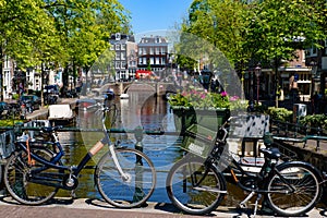 Bikes on the bridge that crosses the canal in Amsterdam