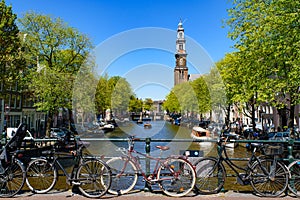 Bikes on the bridge that crosses the canal in Amsterdam