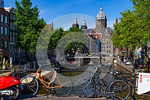 Bikes on the bridge that crosses the canal in Amsterdam