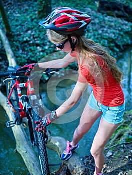 Bikes cycling girl cycling fording throught water .