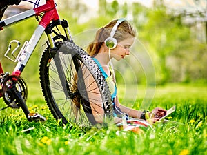 Bikes cycling girl wearing headset watch in pc tablet near bicycle.