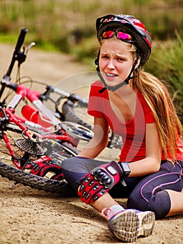 Bikes cycling girl wearing helmet fell off bike.