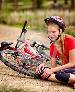 Bikes cycling girl wearing helmet. Kid fell off bike.