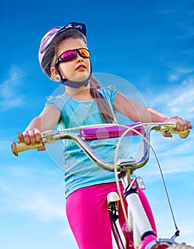 Bikes cycling girl wearing helmet rides bicycle.