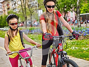 Bikes cycling girls with rucksack on bike lane.