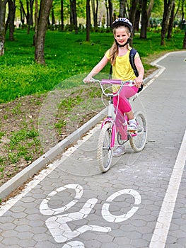 Bikes cycling girls with rucksack cycling on bike lane.