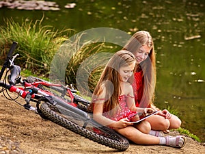 Bikes cycling kids. Girl recreation near bicycle into park.