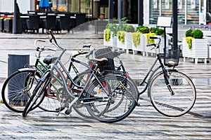 Bikes parked on street in rainy weather