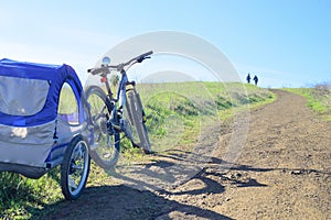 Biking in the hills with child trailer