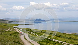 Biking on a Two-track alongside a large lake