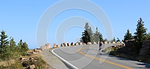 Biking uphill on a curved road on a summer day