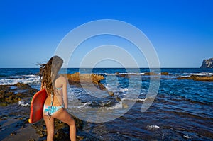 Bikini girl hording surf board in beach