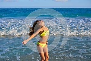 Bikini girl jumping in Caribbean sunset beach