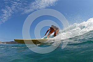 A bikini longboard surfer