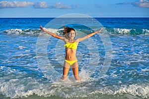 Bikini girl jumping in Caribbean sunset beach