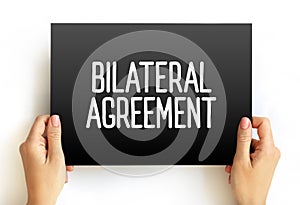 Bilateral Agreement text on card, concept background