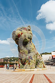 Bilbao, Spain - September, 2022: Puppy, the floral dog sculpture designed by Jeff Koons, in front of the Guggenheim museum of