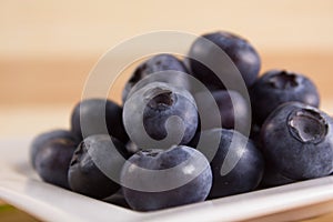 Bilberries close on a white plate