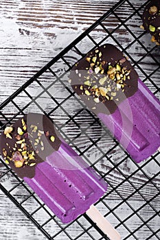 Bilberry ice-cream decorated with chocolate and pistachio nuts