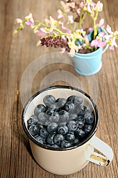 Bilberry in white enameled mug