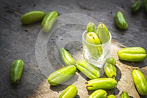 Bilimbi fruits in glass on wooden background.
