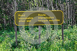 A bilingual road impassable when wet sign