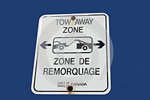 Bilingual tow away zone sign