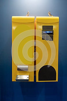 Bill changer machine in yellow color against blue