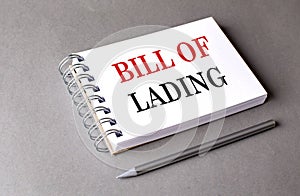 BILL OF LADING text on notebook on grey background photo