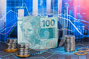 BILL OF 100 REAIS BRAZILIAN MONEY ON A FINANCIAL MARKET GRAPHIC photo