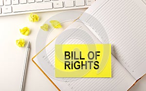 BILL OF RIGHTS text on the sticker on the diary with keyboard and pencil