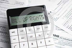 BILL OF RIGHTS word on calculator. Business and tax concept. Time to pay tax in year