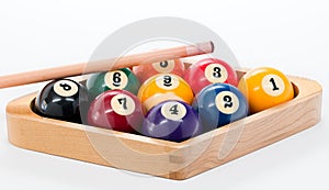 Billard balls racked with a pool cue set for nine ball