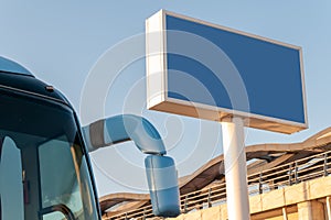 Billboard with blank blue background on the background of a tourist bus