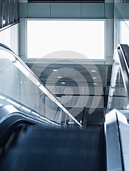 Billboard mocked up in subway station with escalator photo