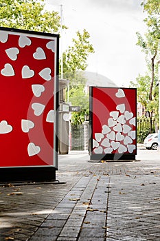 Billboards with heart photographs at city street