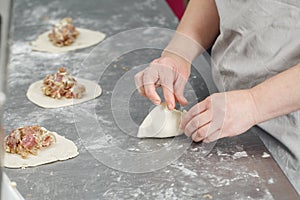 Billet bun of dough with filling inside. Prepared for baking in baking production. photo