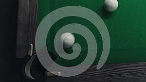 Billiard ball on the billiard green table, top view. The white ball for Russian billiards falls into the hole.