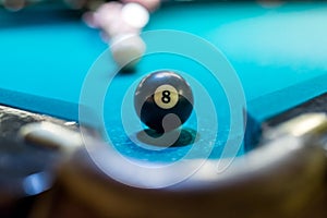 Billiard ball is on billiard table.