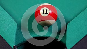 Billiard ball falling into billiard table hole